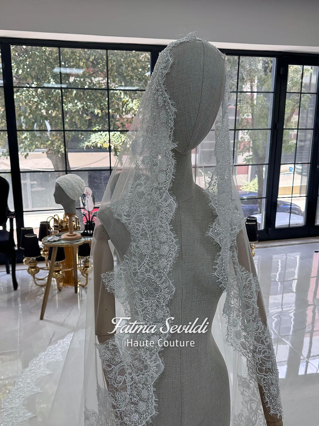 White hijab wedding dress with long sleeves, floral lace, high neckline and detachable overskirt, styled with a premium lace veil. Luxury modest bridal gown designed for a fully covered Muslim bridal look.