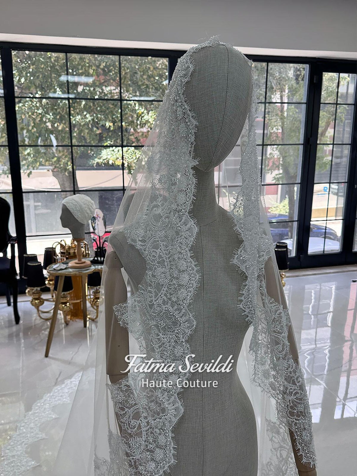 White hijab wedding dress with long sleeves, floral lace, high neckline and detachable overskirt, styled with a premium lace veil. Luxury modest bridal gown designed for a fully covered Muslim bridal look.