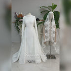Luxury hijab wedding dress with long sleeves, high mock neck, floral lace embroidery, detachable mermaid skirt, dramatic train and premium lace veil for a modest Muslim bride.