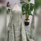Sage green evening dress with beaded floral lace, a sweetheart neckline and long sleeves with flared lace cuffs, displayed on a mannequin.